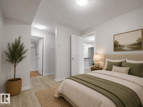 Light wood-finish flooring, white walls, and recessed lighting - #205 5816 Mullen Pl Nw, Edmonton, AB - Indoor Photo Showing Bedroom