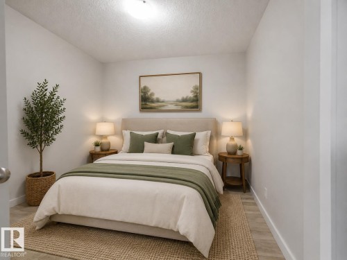 Recessed lighting illuminates neutral-toned walls - #205 5816 Mullen Pl Nw, Edmonton, AB - Indoor Photo Showing Bedroom