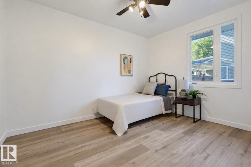 Wood-finish flooring, white walls, and a white-framed window - 9127 149 Street Nw, Edmonton, AB - Indoor Photo Showing Bedroom