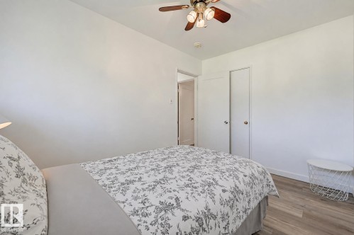Room featuring wood-finish flooring, white walls, and a ceiling fan with integrated lighting - 9127 149 Street Nw, Edmonton, AB - Indoor Photo Showing Bedroom