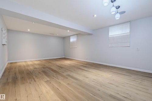 Recessed lighting, wood-finish flooring, and a contemporary ceiling fixture - 9127 149 Street Nw, Edmonton, AB - Indoor