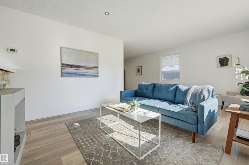 Recessed lighting, wood-finish flooring, white walls, and a window with a roller blind - 9127 149 Street Nw, Edmonton, AB - Indoor Photo Showing Living Room