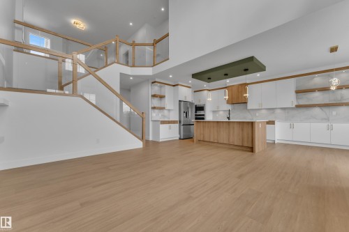 Open-concept living area with wood-finish flooring - 764 Astoria Way, Devon, AB - Indoor Photo Showing Kitchen