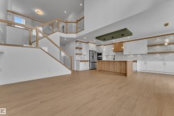 Open-concept living area with wood-finish flooring - 