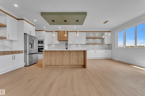 Open-concept living space with light wood-finish flooring - 764 Astoria Way, Devon, AB - Indoor Photo Showing Kitchen