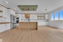 Open-concept living space with light wood-finish flooring - 