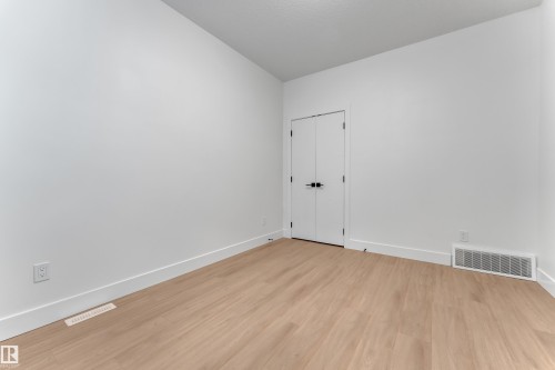 Light wood-finish flooring, crisp white walls, and bright white trim - 764 Astoria Way, Devon, AB - Indoor Photo Showing Other Room