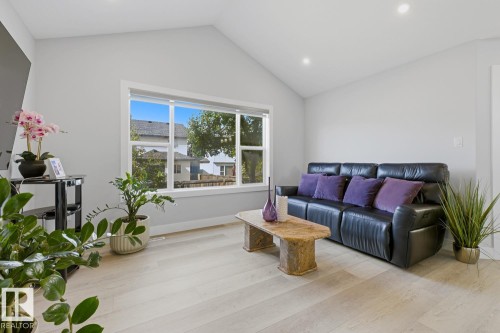 Vaulted ceiling, recessed lighting, large pane windows, light wood-finish flooring, and neutral wall tones - 11816 168 Avenue Nw, Edmonton, AB - Indoor Photo Showing Living Room