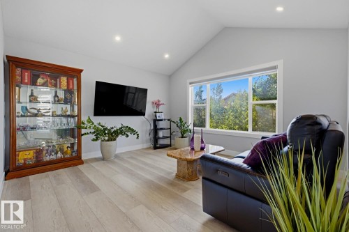 Vaulted ceiling, recessed lighting, expansive window, light wood-finish flooring, and light gray walls - 11816 168 Avenue Nw, Edmonton, AB - Indoor Photo Showing Living Room