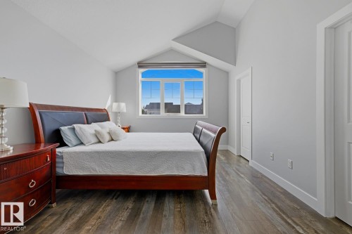 Vaulted ceiling, wood-finish flooring, white trim, and a window with a sloped frame - 11816 168 Avenue Nw, Edmonton, AB - Indoor Photo Showing Bedroom