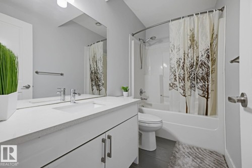 White vanity with a single basin, chrome faucet, and integrated mirror - 11816 168 Avenue Nw, Edmonton, AB - Indoor Photo Showing Bathroom