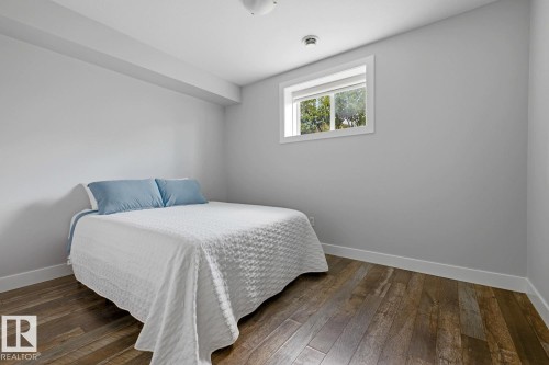 Wood-finish flooring, white trim, and a window with white casing - 11816 168 Avenue Nw, Edmonton, AB - Indoor Photo Showing Bedroom