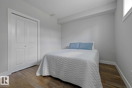 Neutral wall tones with wood-finish flooring - 11816 168 Avenue Nw, Edmonton, AB - Indoor Photo Showing Bedroom