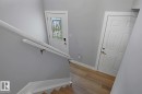 Wood-finish flooring with white trim - 11816 168 Avenue Nw, Edmonton, AB  - Indoor Photo Showing Other Room 