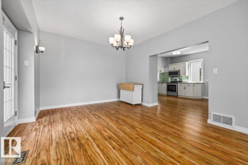 Wood-finish flooring throughout, paired with light gray wall tones - 11429 64 Street Nw, Edmonton, AB - Indoor