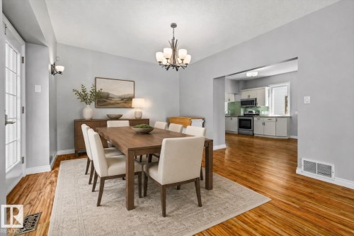 Wood-finish flooring, recessed lighting, and a chandelier illuminate the dining space - 11429 64 Street Nw, Edmonton, AB - Indoor Photo Showing Dining Room