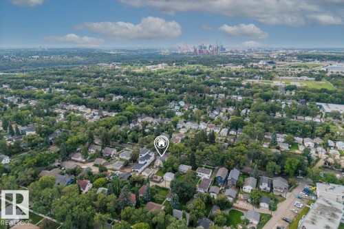 Aerial perspective of a verdant residential area featuring a prominent urban skyline in the distance - 11429 64 Street Nw, Edmonton, AB - Outdoor With View