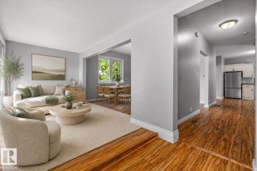 Wood-finish flooring throughout, light gray wall tones, recessed lighting, and white trim accents - 11429 64 Street Nw, Edmonton, AB - Indoor