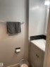 Bathroom vanity featuring a white rectangular sink, light gray cabinetry with brushed nickel hardware, and a dark mosaic tile backsplash - 3221 132A Avenue Nw, Edmonton, AB  - Indoor Photo Showing Bathroom 