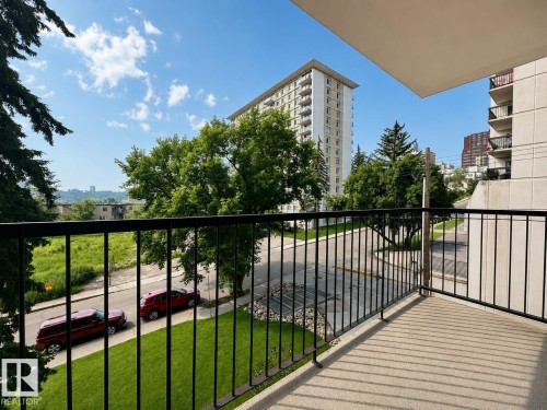 Balcony with black metal railings and concrete flooring - #301 9808 103 St Nw, Edmonton, AB - Outdoor With Balcony With Exterior