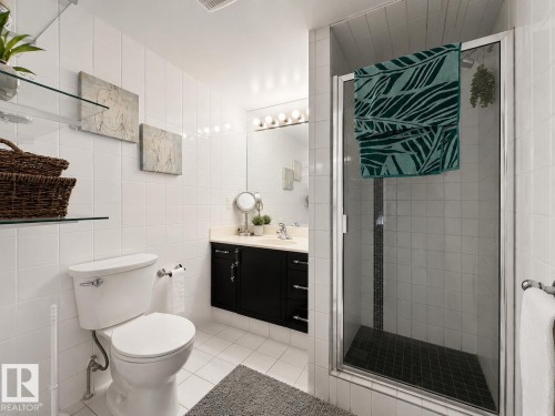 Bathroom featuring white tiled walls and flooring - #301 9808 103 St Nw, Edmonton, AB - Indoor Photo Showing Bathroom