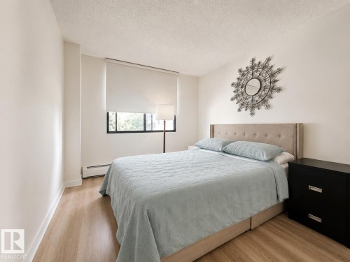 Windowed room with light wood-finish flooring - #301 9808 103 St Nw, Edmonton, AB - Indoor Photo Showing Bedroom