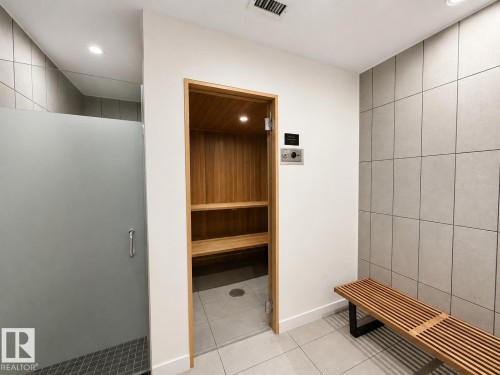 Dedicated sauna with wood-finish interior and integrated bench seating - #301 9808 103 St Nw, Edmonton, AB - Indoor