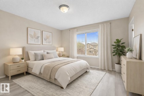 Spacious room featuring light-toned walls and wood-finish flooring - 21344 88 Avenue Nw, Edmonton, AB - Indoor Photo Showing Bedroom