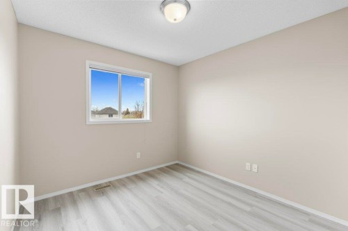 Neutral painted walls with light wood-finish flooring - 21344 88 Avenue Nw, Edmonton, AB - Indoor Photo Showing Other Room