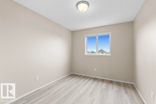 Bright interior space featuring light wood-finish flooring and a neutral wall palette - 21344 88 Avenue Nw, Edmonton, AB - Indoor Photo Showing Other Room