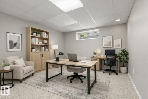 Recessed lighting and drop ceiling panels illuminate this versatile room with light gray walls and plush carpet flooring - 21344 88 Avenue Nw, Edmonton, AB - Indoor Photo Showing Office