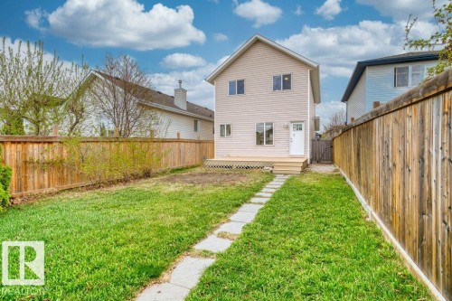 Expansive backyard featuring a manicured lawn, a stone paver pathway, and a wood deck - 21344 88 Avenue Nw, Edmonton, AB - Outdoor