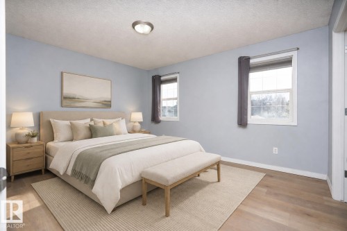 Wood-finish flooring with a neutral wall color - 1009 Macewan Close Sw, Edmonton, AB - Indoor Photo Showing Bedroom