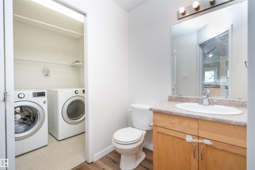 Integrated laundry closet with wire shelving - 1009 Macewan Close Sw, Edmonton, AB - Indoor Photo Showing Laundry Room
