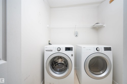 Dedicated laundry area with a wire storage shelf - 1009 Macewan Close Sw, Edmonton, AB - Indoor Photo Showing Laundry Room
