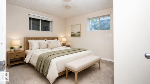 Soft neutral wall paint and carpeting create a serene atmosphere - 1009 Macewan Close Sw, Edmonton, AB - Indoor Photo Showing Bedroom