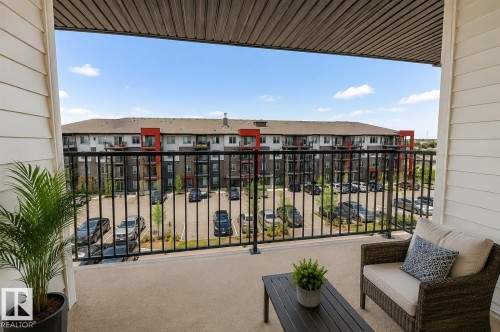 Private balcony with concrete flooring, black metal railing, and horizontal siding - #430 5515 7 Av Sw, Edmonton, AB - Outdoor With Balcony With Exterior