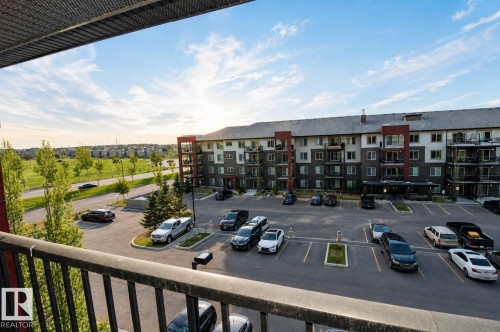 Multi-story building featuring balconies, dedicated parking, and a paved lot - #430 5515 7 Av Sw, Edmonton, AB - Outdoor With Balcony