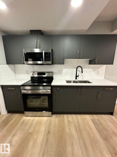 #Bsmt 3922 40 Av, Beaumont, AB - Indoor Photo Showing Kitchen With Stainless Steel Kitchen With Double Sink With Upgraded Kitchen