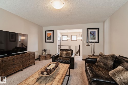 Neutral-toned walls complement the textured ceiling - 1337 Secord Landing Nw, Edmonton, AB - Indoor Photo Showing Living Room