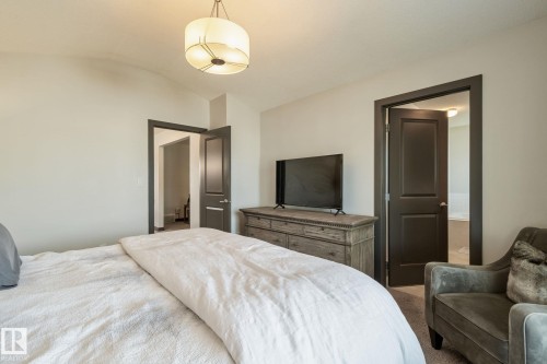 Vaulted ceiling with a drum pendant light fixture - 1337 Secord Landing Nw, Edmonton, AB - Indoor Photo Showing Bedroom