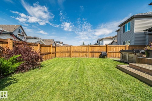 Expansive backyard featuring a manicured lawn, established landscaping, and a wood privacy fence - 1337 Secord Landing Nw, Edmonton, AB - Outdoor