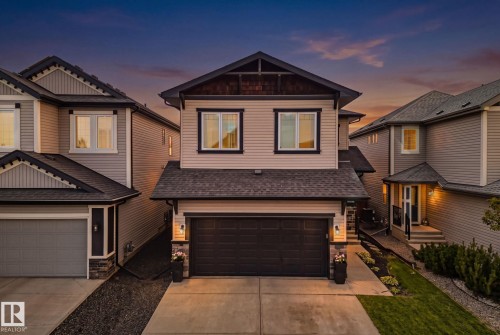 Two-story residence featuring light-toned siding and dark window trim - 1337 Secord Landing Nw, Edmonton, AB - Outdoor