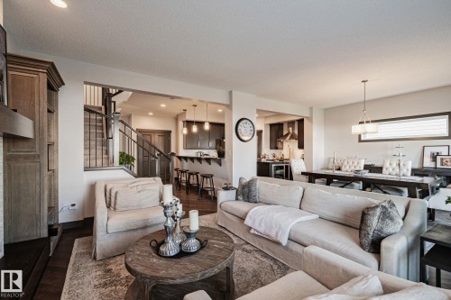 Open-concept living space featuring wood-finish flooring and recessed lighting - 1337 Secord Landing Nw, Edmonton, AB - Indoor Photo Showing Living Room