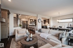 Open-concept living space featuring wood-finish flooring and recessed lighting - 