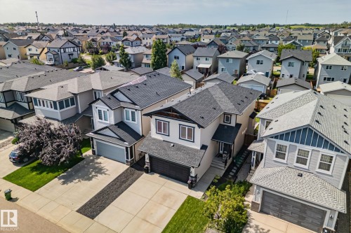 Modern two-story residence with a multi-gabled roofline, light-toned siding, and dark trim accents - 1337 Secord Landing Nw, Edmonton, AB - Outdoor