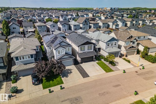 Contemporary-style residence with solar panels, an attached garage, and a concrete driveway - 1337 Secord Landing Nw, Edmonton, AB - Outdoor With Facade