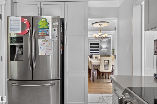 Stainless steel refrigerator integrated with light gray cabinetry - 8632 184 Street Nw, Edmonton, AB - Indoor