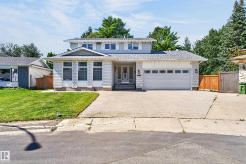 Two-story residence featuring a two-car garage, concrete driveway, and a front lawn with established landscaping - 8632 184 Street Nw, Edmonton, AB - Outdoor With Facade
