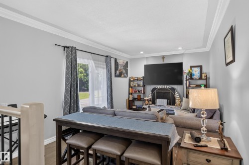 Crown molding, wood-finish flooring, and a fireplace with a decorative screen - 8632 184 Street Nw, Edmonton, AB - Indoor